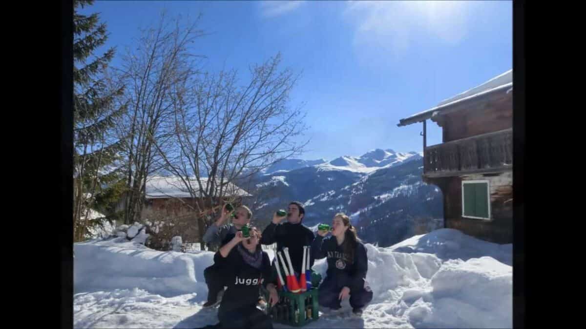 Friends drinking in snowy Swiss Alps, possibly near Ulm - Passing Zone