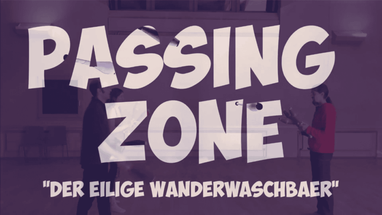 Passing Zone: "Der eilige Wanderwaschbaer" title card. People in a room with the title overlayed. - Passing Zone